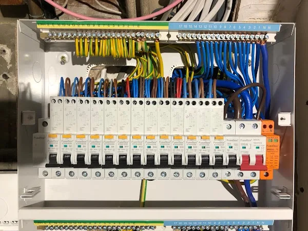 Open consumer unit showing neatly arranged electrical wiring